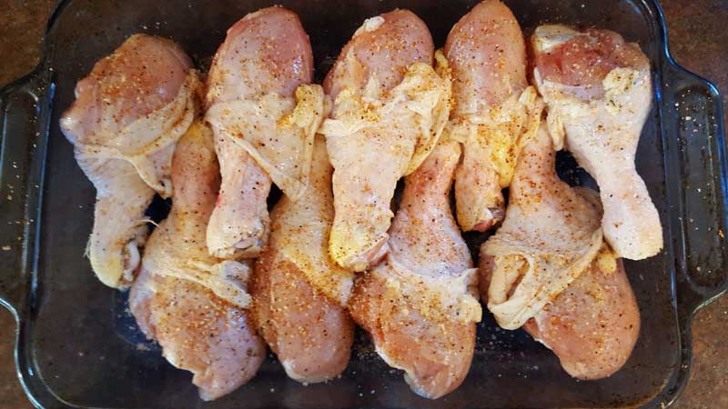 Chicken legs sprinkled with rub.