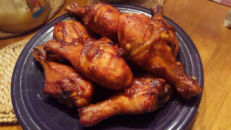Barbecue chicken thighs on a plate.