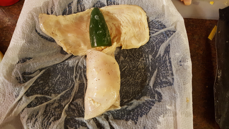 Chicken fillet with a stuffed jalapeno on top.