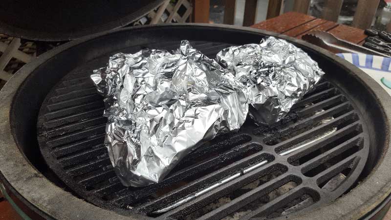 Ribs wrapped in foil packet on the Big Green Egg.