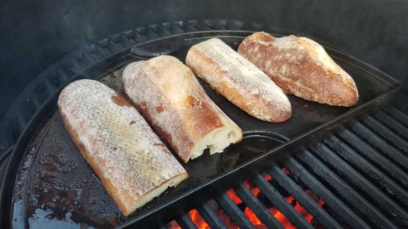 Baguettes toasting on a plancha.