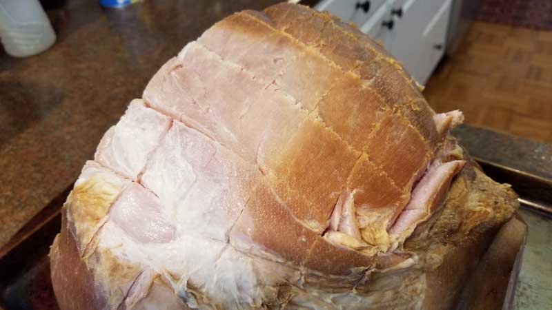 Ham with crisscrossed slices running through the top.