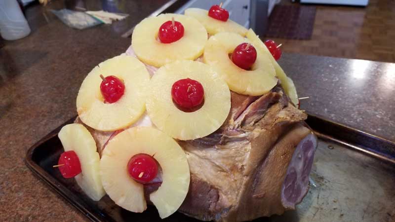 Ham covered in pineapple and maraschino cherries.