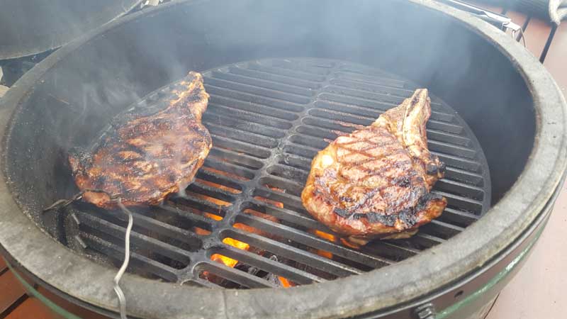 rib eye steaks flipped with the grill mark lined side up.