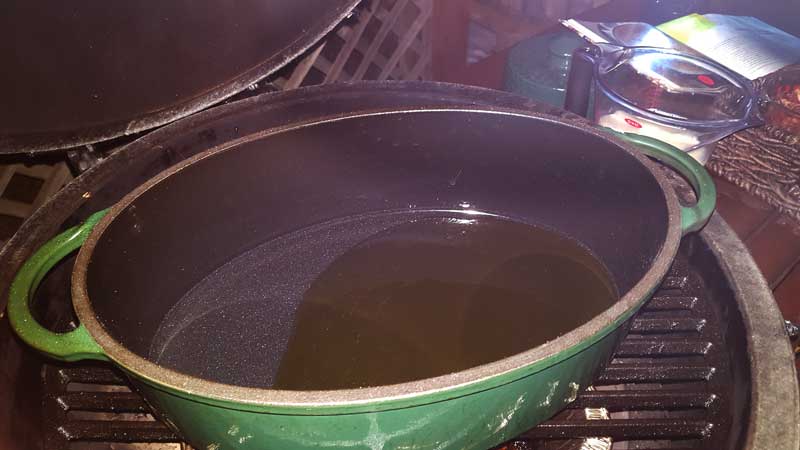 Olive oil heating in a Dutch oven.