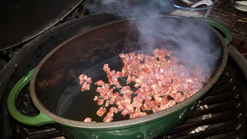 Chorizo cooking in a Dutch oven.