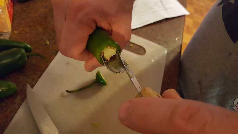 Coring a jalapeno pepper.