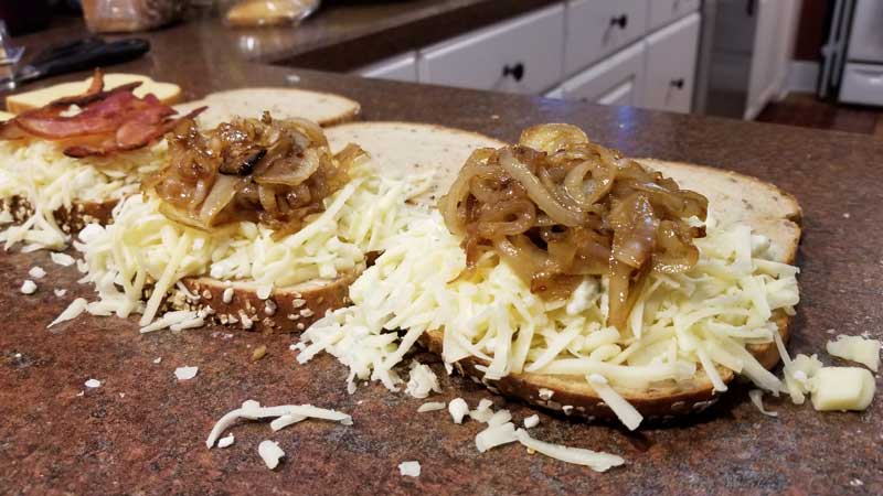Fried onions and cheese on a slice of bread.