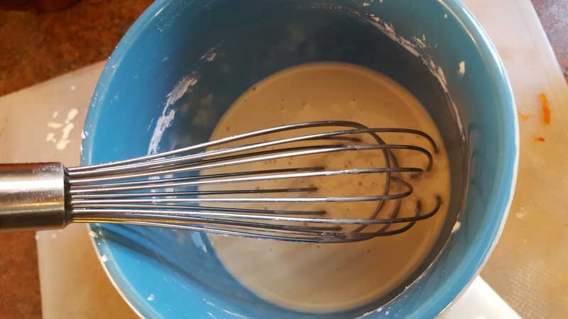 Whisk mixing corn starch and amaretto.