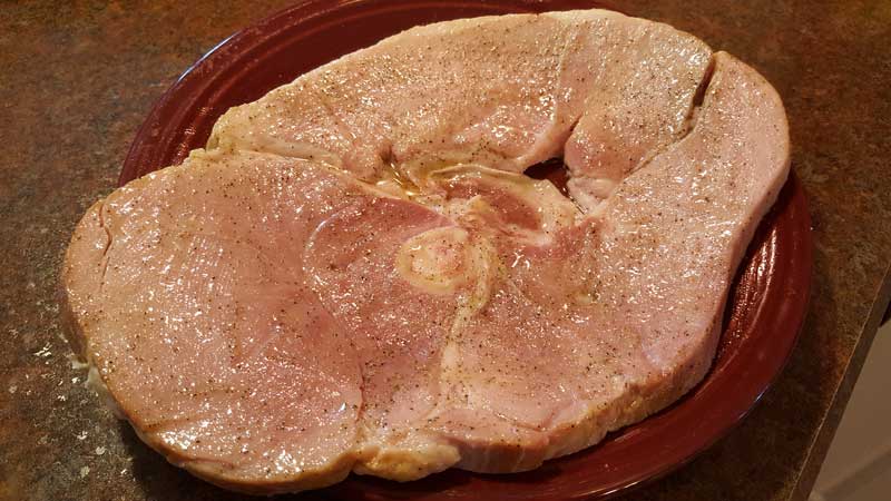 Ham steak with olive oil and pepper brushed on.