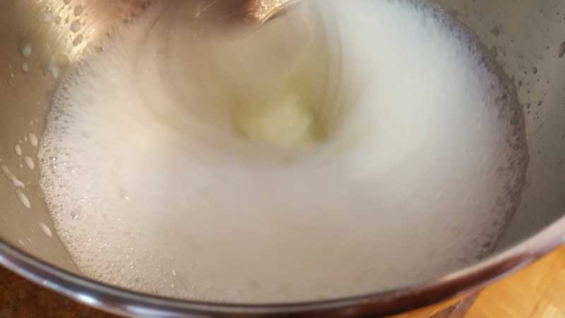 Egg and milk blending in a mixer.