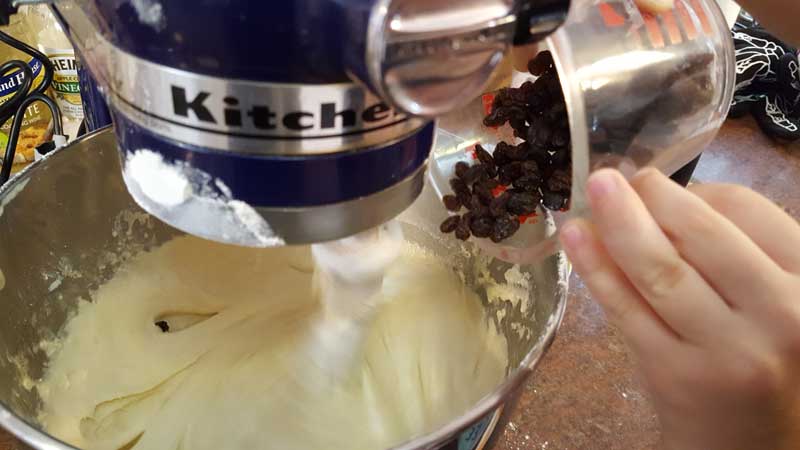 Raisins being added to the mixture.