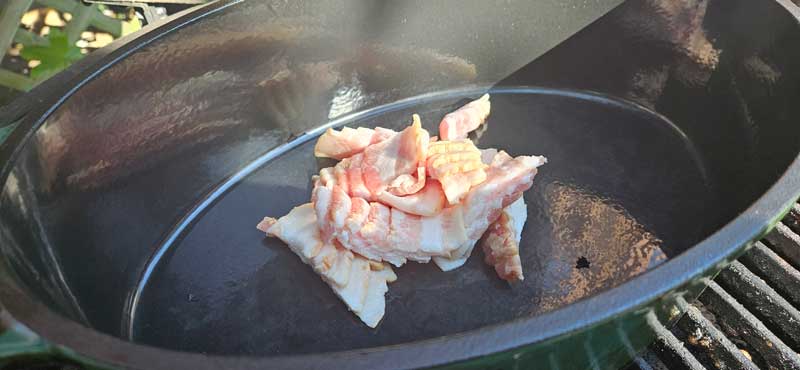 Diced bacon in a Dutch oven.