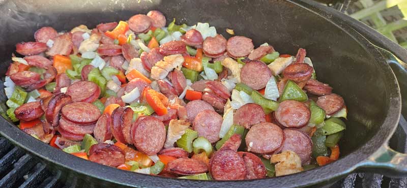 Onion, peppers, and celery mixed into chicken and kielbasa.