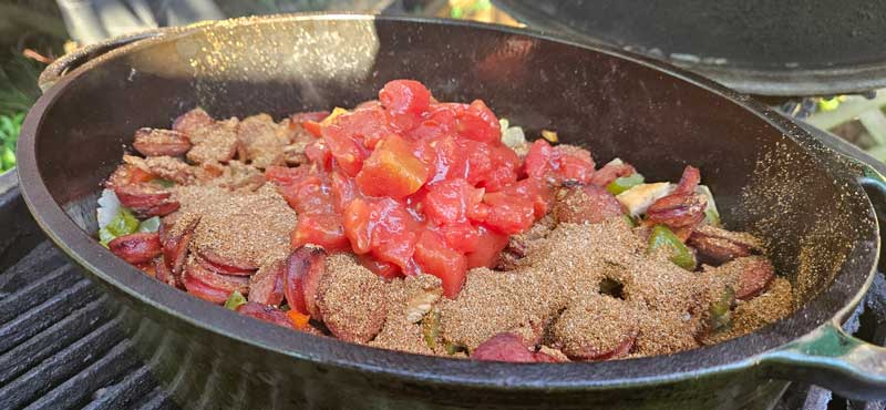 Diced tomatoes and Cajun seasoning added to the Dutch oven.