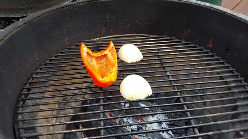 Pepper and onion roasting on the Big Green Egg