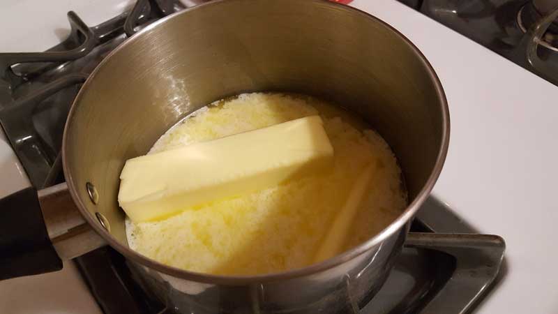 Sticks of butter melting in a pot.