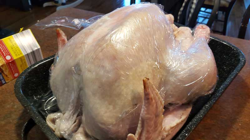 Turkey wrapped in plastic wrap.