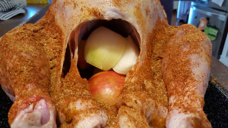 Sliced onion and apple in the turkey cavity.