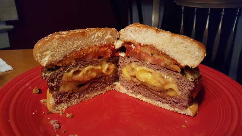 Stuffed burger cut open to show the mac and cheese inside.