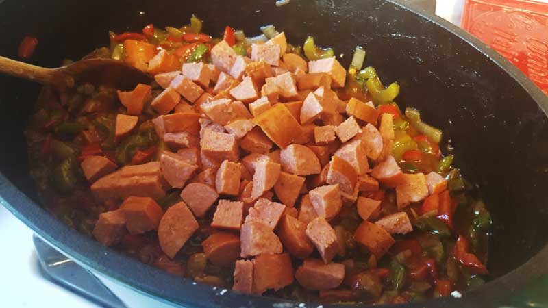 Diced andouille sausage on the vegetable roux.
