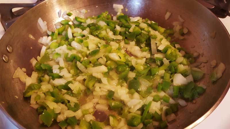 Peppers and onions in frying pan