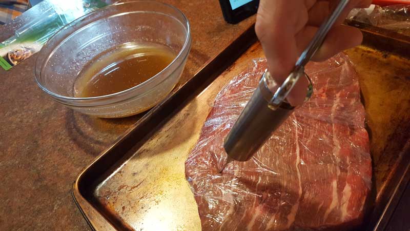 Brine being injected into the brisket.