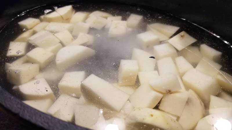 Cubed potatoes in water.