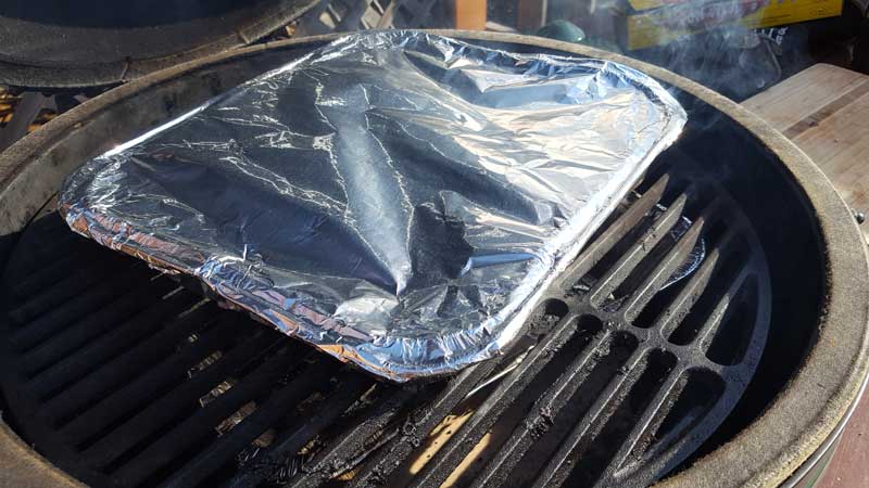 Pan covered with foil in a Big Green Egg.