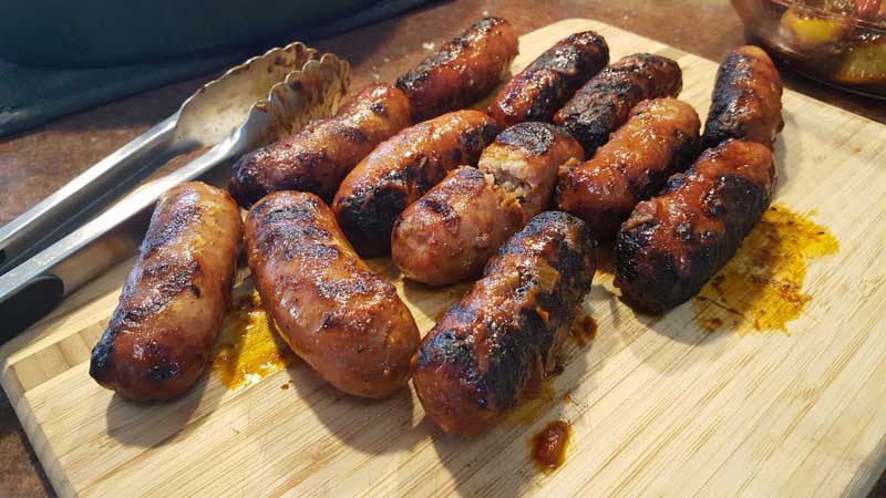 Sausage cooling on a cutting board.