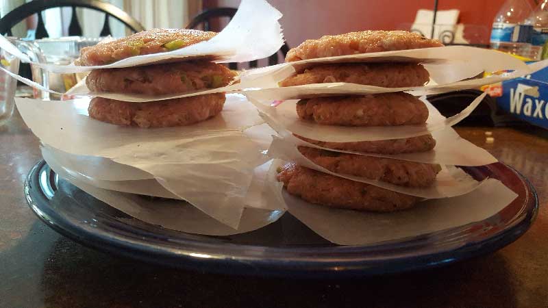 Ground pork patties stacked on top of each other.