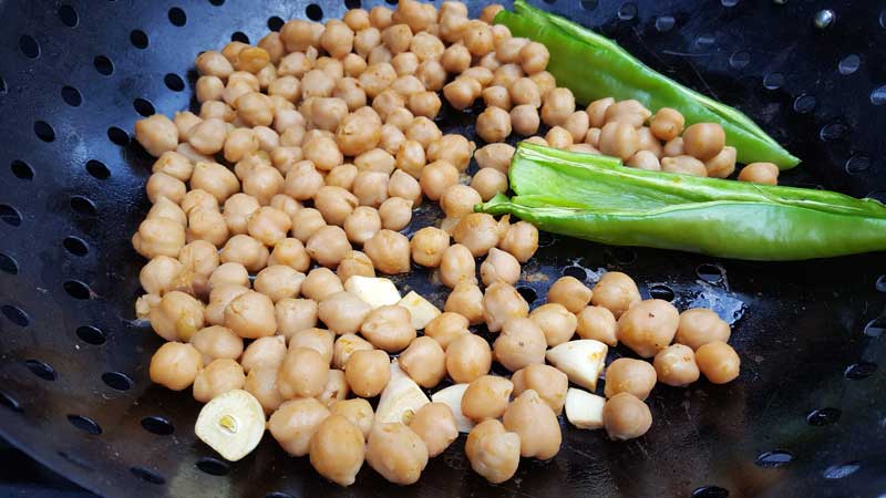 Chick peas with garlic and chiles on the Big Green Egg.