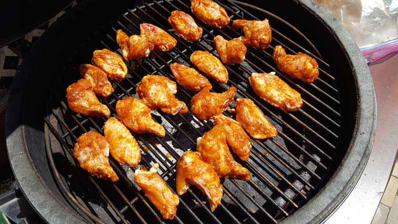 Wings covered in rub on the Big Green Egg.