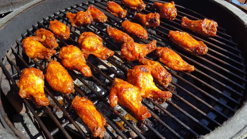 Wings coated in barbecue sauce.