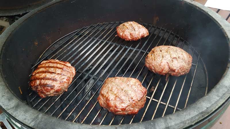 Burgers grilling on the Big Green Egg.